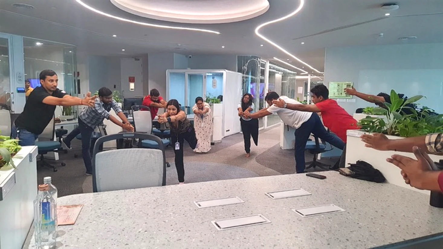 Employees practising a chair-supported balance exercise
